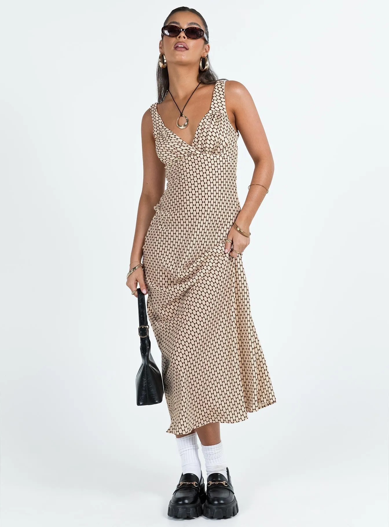 With a flattering shape and versatile design this dress is perfect for all occasions Maysa Geo Maxi Dress Beige