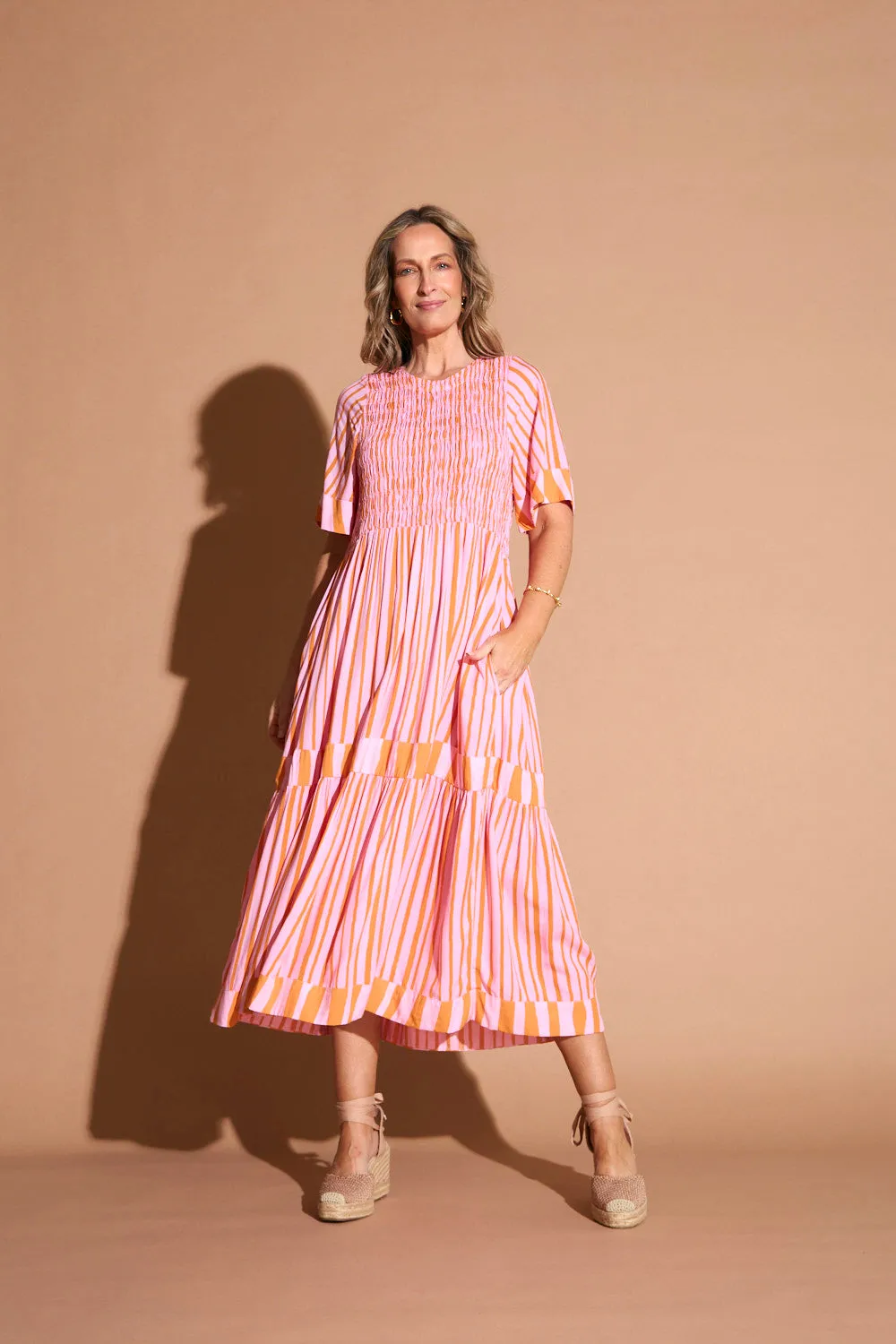 Feminine fit-and-flare style Minden Shirred Dress in Coral Spring